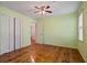 Bedroom featuring hardwood floors, ceiling fan, closet, and neutral paint at 3627 Pebble Hill Ne Dr, Marietta, GA 30062