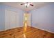 Bright bedroom features hardwood floors, ceiling fan, and a double-door closet for ample storage at 3627 Pebble Hill Ne Dr, Marietta, GA 30062