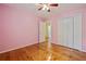 Bedroom featuring hardwood floors, ceiling fan, closet, and neutral paint at 3627 Pebble Hill Ne Dr, Marietta, GA 30062