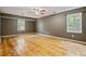 Large bedroom features multiple windows, hardwood floors, and ceiling fan at 3627 Pebble Hill Ne Dr, Marietta, GA 30062
