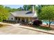 Community clubhouse featuring a welcoming porch with accessibility ramp and landscaped surroundings near a pool at 3627 Pebble Hill Ne Dr, Marietta, GA 30062