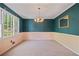 Inviting dining room has large window, decorative mirror, and elegant chandelier at 3627 Pebble Hill Ne Dr, Marietta, GA 30062
