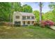 Charming two-story home with a manicured lawn and mature landscaping at 3627 Pebble Hill Ne Dr, Marietta, GA 30062