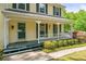 Inviting front porch with charming details, seating, and lush landscaping at 3627 Pebble Hill Ne Dr, Marietta, GA 30062