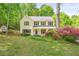 Charming two-story home with green shutters, landscaping, and mature trees at 3627 Pebble Hill Ne Dr, Marietta, GA 30062