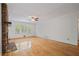 Bright living room boasting hardwood floors, ceiling fan, and stone fireplace at 3627 Pebble Hill Ne Dr, Marietta, GA 30062