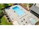 Community pool featuring lounge chairs, tables with umbrellas, and a separate kiddie pool at 3627 Pebble Hill Ne Dr, Marietta, GA 30062