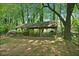 Outdoor wooden pavilion featuring picnic tables and a serene setting, perfect for gatherings and enjoying the natural surroundings at 3627 Pebble Hill Ne Dr, Marietta, GA 30062