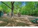 Outdoor playground with swings, slides, climbing structures, and benches surrounded by mature trees in a Gathering-friendly community at 3627 Pebble Hill Ne Dr, Marietta, GA 30062
