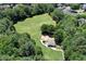 Aerial view of large green field with mature trees and playground at 470 W Magnolia Cir, Johns Creek, GA 30005