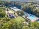 Aerial view of property with pool, tennis court, and well-manicured landscaping at 470 W Magnolia Cir, Johns Creek, GA 30005