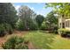 Lush, green backyard with mature trees, offering a serene and private outdoor space for relaxation and recreation at 470 W Magnolia Cir, Johns Creek, GA 30005