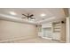 Spacious finished basement offers recessed lighting, plush carpeting, and built-in shelving with decorative crown molding at 470 W Magnolia Cir, Johns Creek, GA 30005