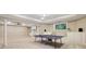 Finished basement with a ping pong table, built-in cabinets, and neutral carpeting, perfect for recreation and entertainment at 470 W Magnolia Cir, Johns Creek, GA 30005