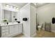 Well-lit bathroom featuring a modern vanity, a toilet with black accents, and neutral walls at 470 W Magnolia Cir, Johns Creek, GA 30005