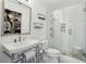 Bathroom featuring a glass enclosed shower, modern sink, and decorative mirror with modern fixtures at 470 W Magnolia Cir, Johns Creek, GA 30005