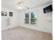 Bedroom features large windows, neutral carpet, and a ceiling fan for a bright, comfortable space at 470 W Magnolia Cir, Johns Creek, GA 30005