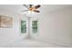 Bright, carpeted bedroom with two windows, white walls, and ceiling fan at 470 W Magnolia Cir, Johns Creek, GA 30005