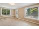 Cozy bedroom with neutral carpeting, two large windows for ample natural light, and a private access door at 470 W Magnolia Cir, Johns Creek, GA 30005