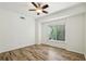 Bright bedroom with natural light, stylish wood flooring, and a large window overlooking lush greenery at 470 W Magnolia Cir, Johns Creek, GA 30005