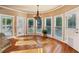 Cozy breakfast nook features many large windows and hardwood floors at 470 W Magnolia Cir, Johns Creek, GA 30005
