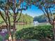 Scenic community view featuring a serene lake with a fountain, surrounded by lush greenery and mature trees at 470 W Magnolia Cir, Johns Creek, GA 30005