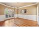 Elegant dining room featuring hardwood floors, wainscoting, and large windows, ideal for hosting gatherings at 470 W Magnolia Cir, Johns Creek, GA 30005