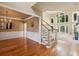 Inviting foyer with hardwood floors and staircase, leading to an open-concept living area with ample natural light at 470 W Magnolia Cir, Johns Creek, GA 30005