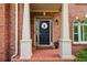Beautiful brick home featuring a classic front door with sidelights and columns at 470 W Magnolia Cir, Johns Creek, GA 30005