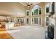 Bright living room boasts soaring ceilings, a fireplace, and large windows offering scenic views of the outdoors at 470 W Magnolia Cir, Johns Creek, GA 30005