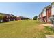 Spacious backyard featuring exterior of brick and white siding townhomes at 7712 Autry Circle # 204, Douglasville, GA 30134
