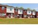 Backyard featuring red brick and white siding townhomes with a large grassy area at 7712 Autry Circle # 204, Douglasville, GA 30134