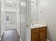 Hallway bathroom with a wood vanity and a view of the entrance to the unit at 7712 Autry Circle # 204, Douglasville, GA 30134