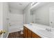 Bathroom with double sink vanity, a large mirror, and a shower-tub combo, offering convenience and functionality at 7712 Autry Circle # 204, Douglasville, GA 30134