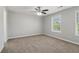 Carpeted bedroom with bright windows and a ceiling fan at 7712 Autry Circle # 204, Douglasville, GA 30134