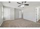 Spacious bedroom with neutral colors, ceiling fan, and plush carpeting, offering a serene and inviting atmosphere at 7712 Autry Circle # 204, Douglasville, GA 30134