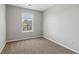 Bright bedroom boasts neutral walls, soft carpeting, and a large window, creating an inviting and comfortable atmosphere at 7712 Autry Circle # 204, Douglasville, GA 30134