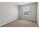 Bright bedroom features neutral walls, soft carpeting, and a window, creating an inviting and pleasant atmosphere at 7712 Autry Circle # 204, Douglasville, GA 30134