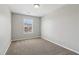 Comfortable bedroom features neutral walls, soft carpeting, and a bright window creating an inviting and pleasant atmosphere at 7712 Autry Circle # 204, Douglasville, GA 30134