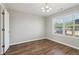 Clean bedroom with wood-look flooring, a large window, and an open doorway to another room at 7712 Autry Circle # 204, Douglasville, GA 30134