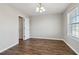 Bright bedroom with wood-look floors, neutral paint, and a window offering pleasant outdoor views at 7712 Autry Circle # 204, Douglasville, GA 30134