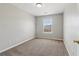 Cozy bedroom featuring neutral walls, soft carpeting, and a bright window creating an inviting and comfortable space at 7712 Autry Circle # 204, Douglasville, GA 30134