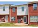 Back exterior view featuring brick and white siding townhomes and backyard at 7712 Autry Circle # 204, Douglasville, GA 30134