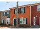 Brick townhouses featuring black and green shutters, creating a charming and traditional street view at 7712 Autry Circle # 204, Douglasville, GA 30134