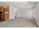 Open-concept living space with carpeted floor, leading to an adjacent kitchen and exterior access at 7712 Autry Circle # 204, Douglasville, GA 30134