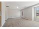 Spacious living room featuring neutral paint, carpet flooring, and natural light from a window at 7712 Autry Circle # 204, Douglasville, GA 30134