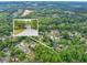 Magnified aerial shot of the home and its location within a community of lush green trees at 2262 Silver Fox Ln, Buford, GA 30519
