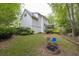 Large backyard featuring mature trees, landscaping, fire pit and outdoor seating at 2262 Silver Fox Ln, Buford, GA 30519