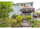 Exterior view of the home featuring a two-tiered deck and beautifully landscaped backyard at 2262 Silver Fox Ln, Buford, GA 30519