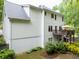 Side view of the home highlighting the expansive backyard, deck, and natural surroundings at 2262 Silver Fox Ln, Buford, GA 30519